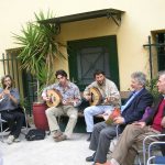 Tassos Photopoulos, teacher of Byzantine music, and musicians in the yard of the office building of the Dora Stratou Dance Theater